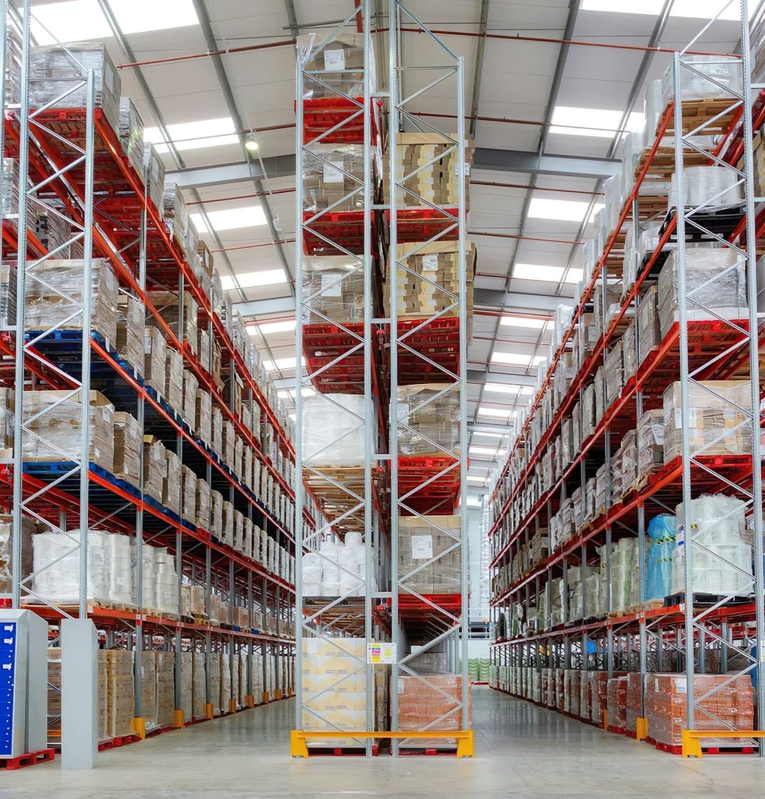Racking aisle stacked with pallets in a food and drink distribution warehouse